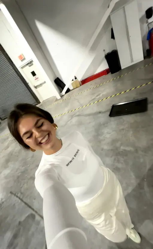 Maria smiling in a hangar before a night flight