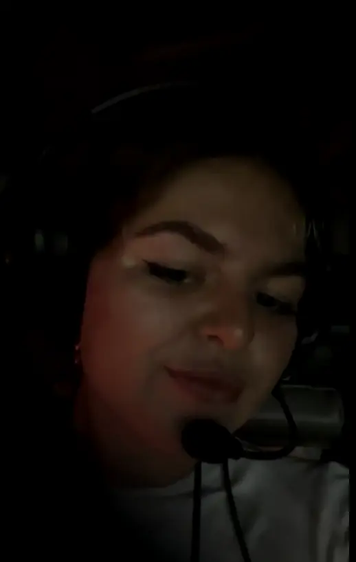 Close portrait of Maria in a helicopter headset at night